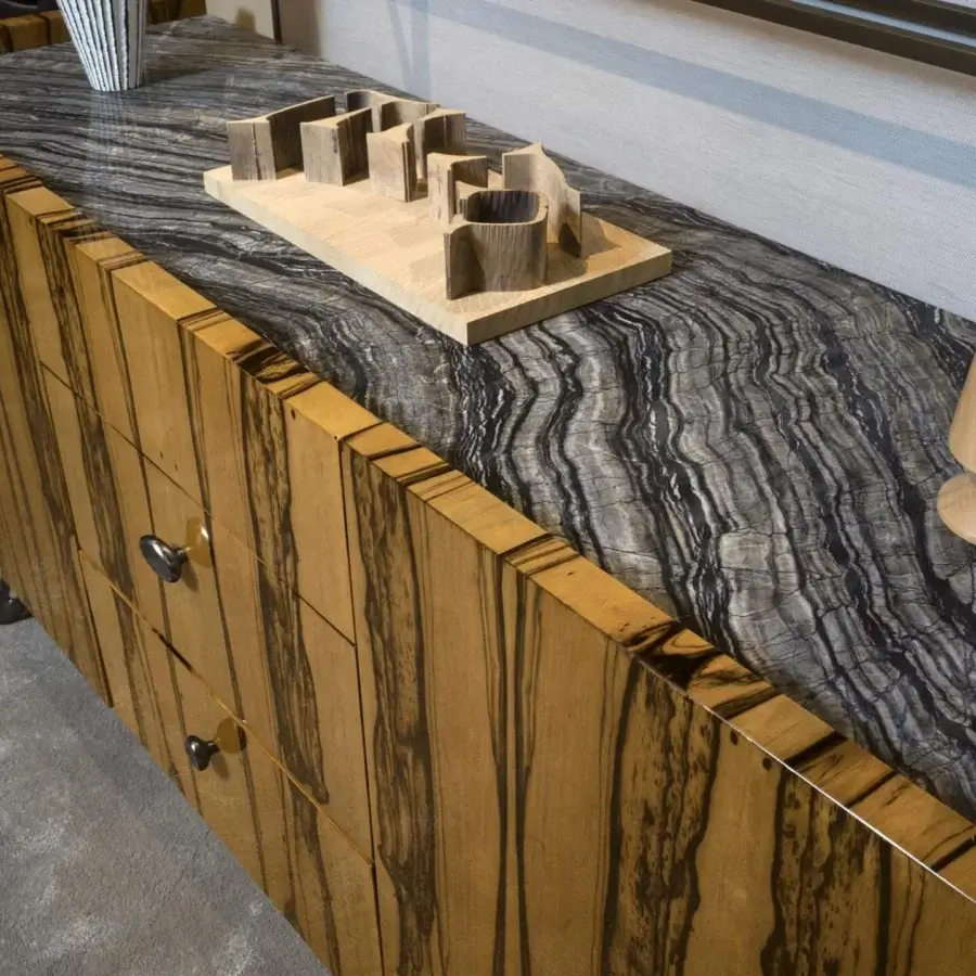 Distinguished BelMondo by Bellotti Ezio Atena sideboard with dark wood panels and marble-patterned top accented by sculptural knobs