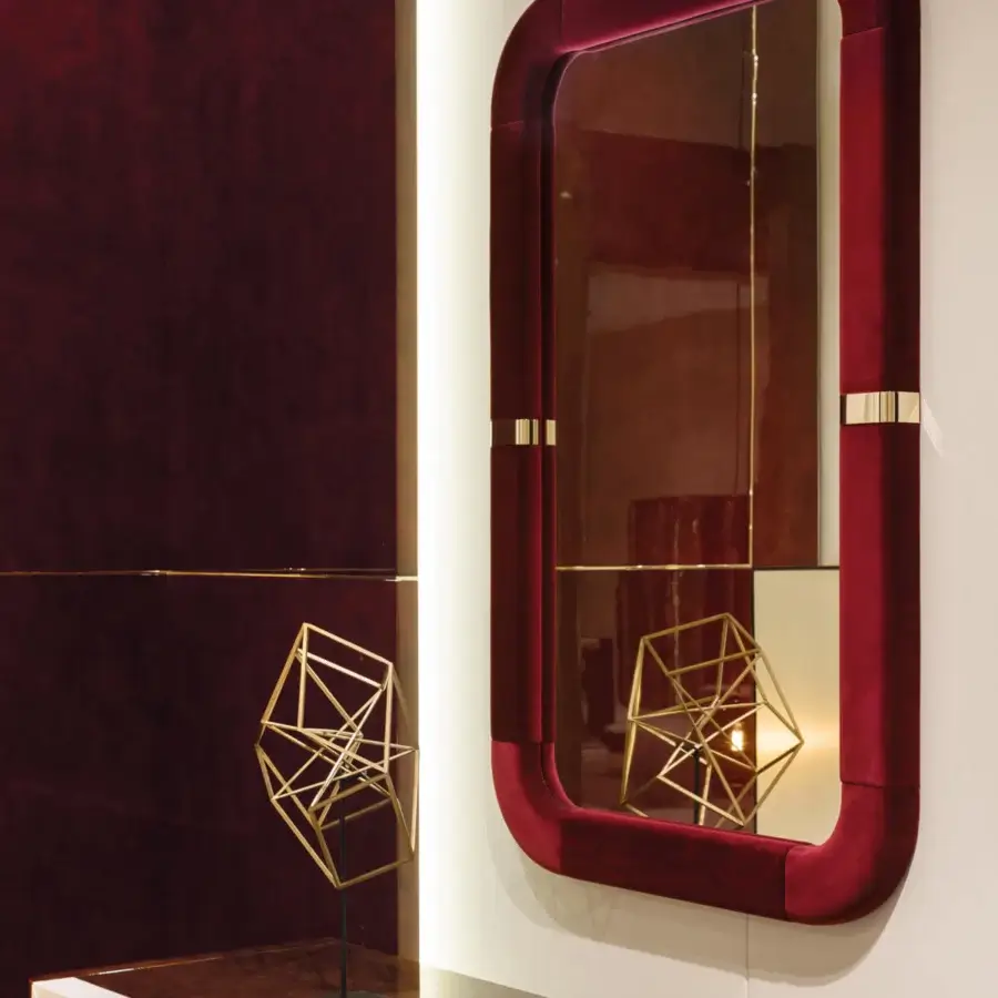 Sumptuous Turri Madison mirror with a rectangular frame covered in dark red plush material and light gold metal details