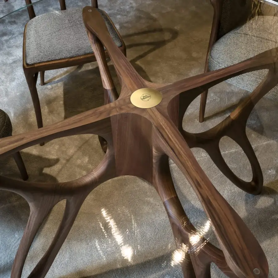Harmonious BelMondo by Bellotti Ezio Prometeo round table with warm medium-brown wood base and transparent glass top crafted in Italy