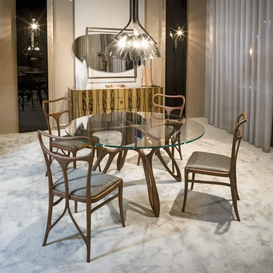 Exceptional BelMondo by Bellotti Ezio Prometeo round table with sculptural wooden base and clear glass top in medium-toned brown finish