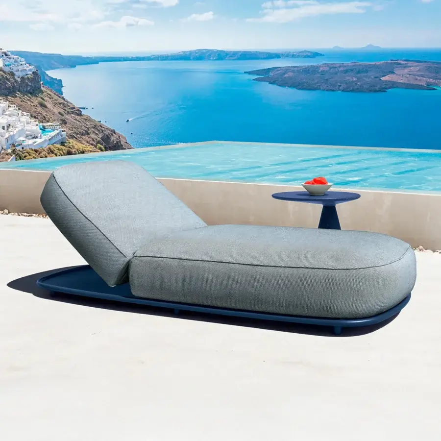Sophisticated Talenti Swipe lounger with muted gray fabric upholstery and a dark blue base conveys lightness