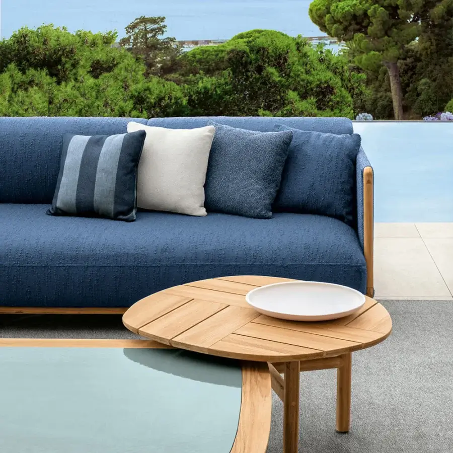 Superior Talenti Jun sofa with warm teak structure and textured blue textile cushions including a striped accent pillow