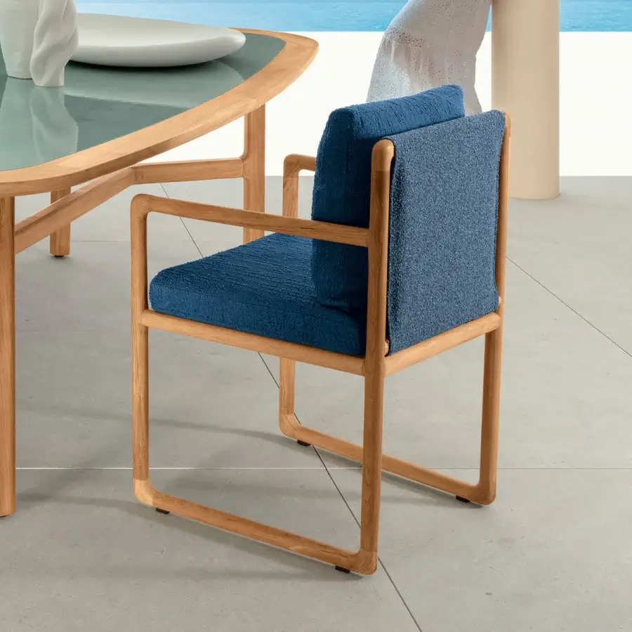 Superior Talenti Jun armchair with solid teak wood structure and textured blue cushions exhibiting a light-toned matte finish