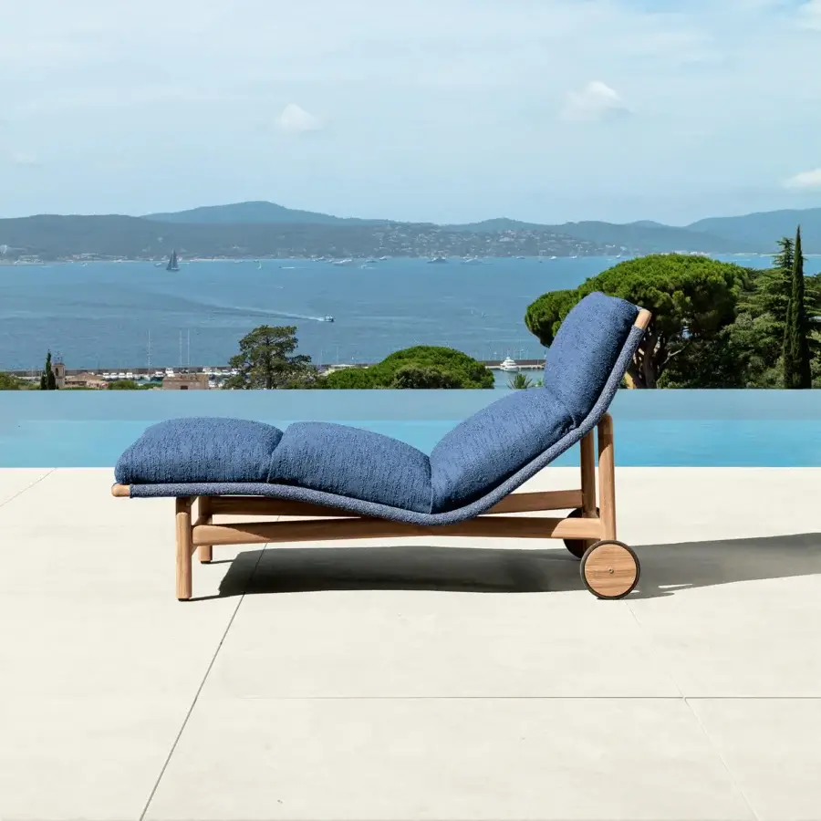Sophisticated Talenti Jun lounger with cool blue bouclé fabric and a light-toned wooden structure crafted for relaxation