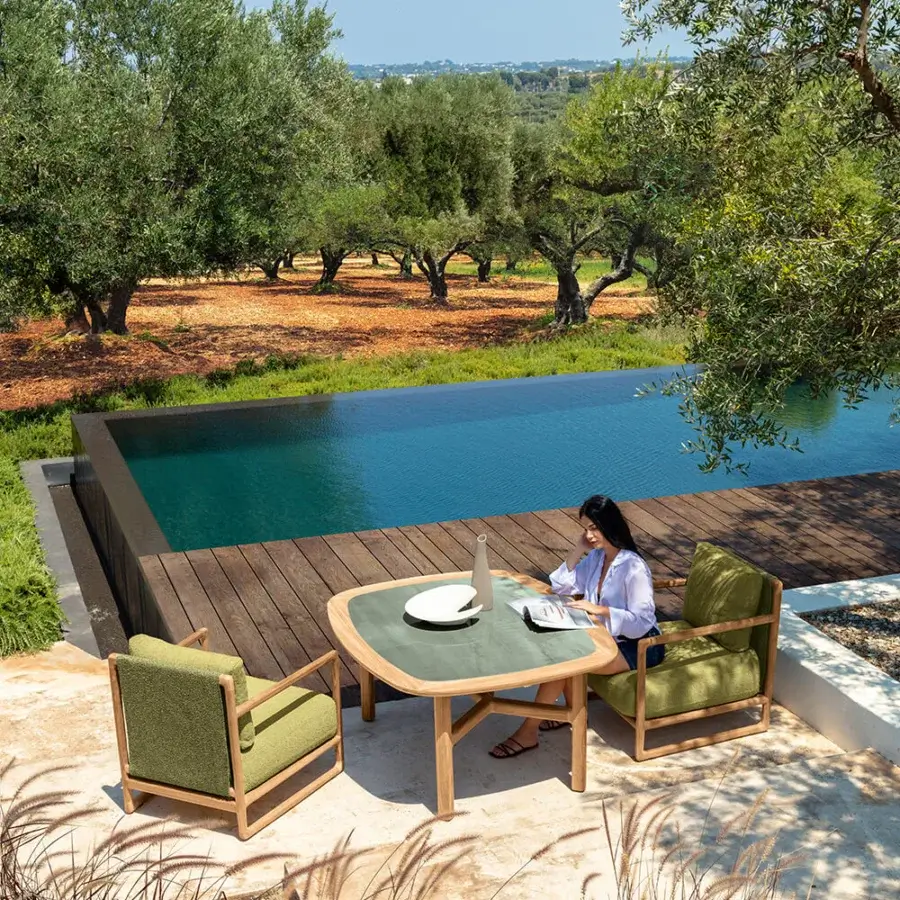 Sophisticated Talenti Jun table crafted in natural teak with a smooth, rounded square gres top exhibiting a green finish