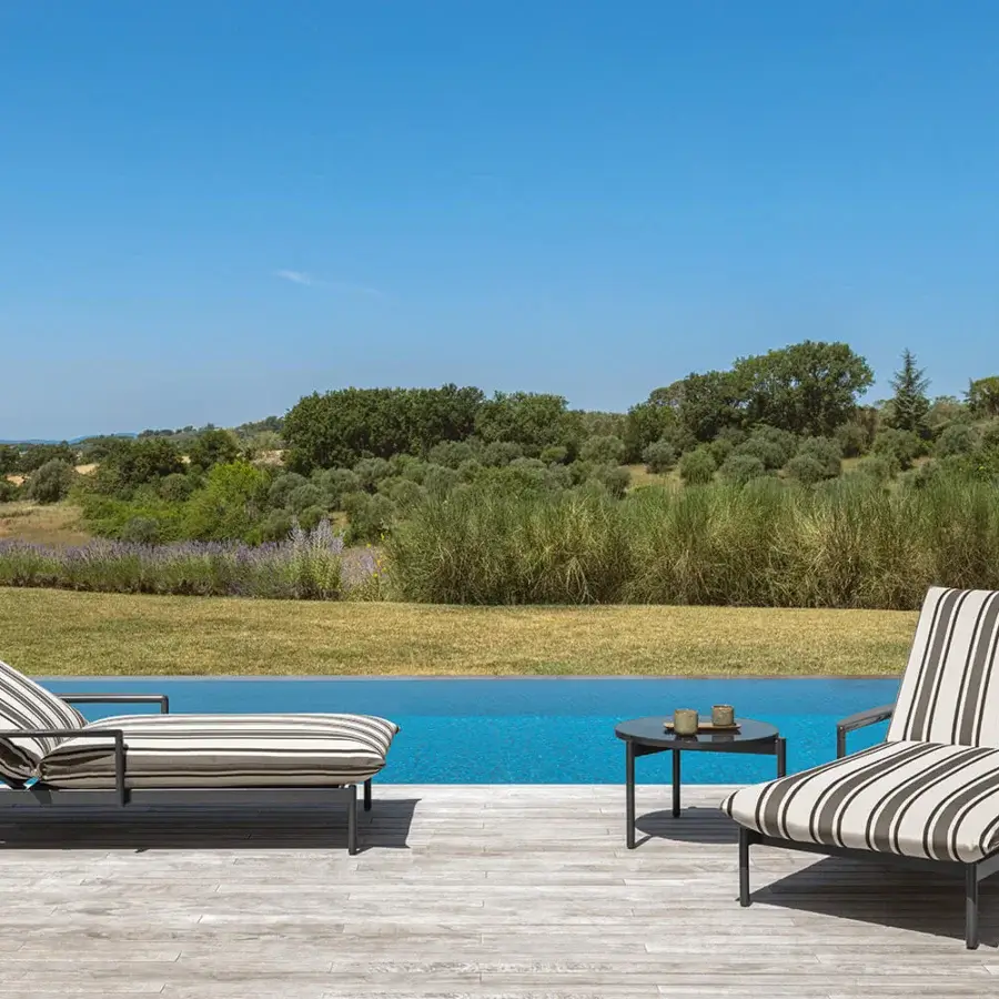 Superior Talenti Nalu lounger with striped upholstery and matte dark gray metal frame built for poolside comfort