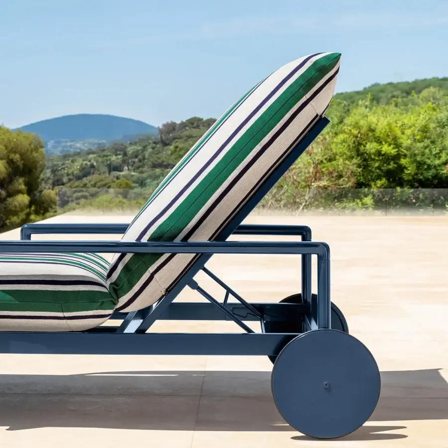 Exceptional Talenti Nalu lounger with a matte dark blue metal frame and striped cushions in green, beige, and navy blue