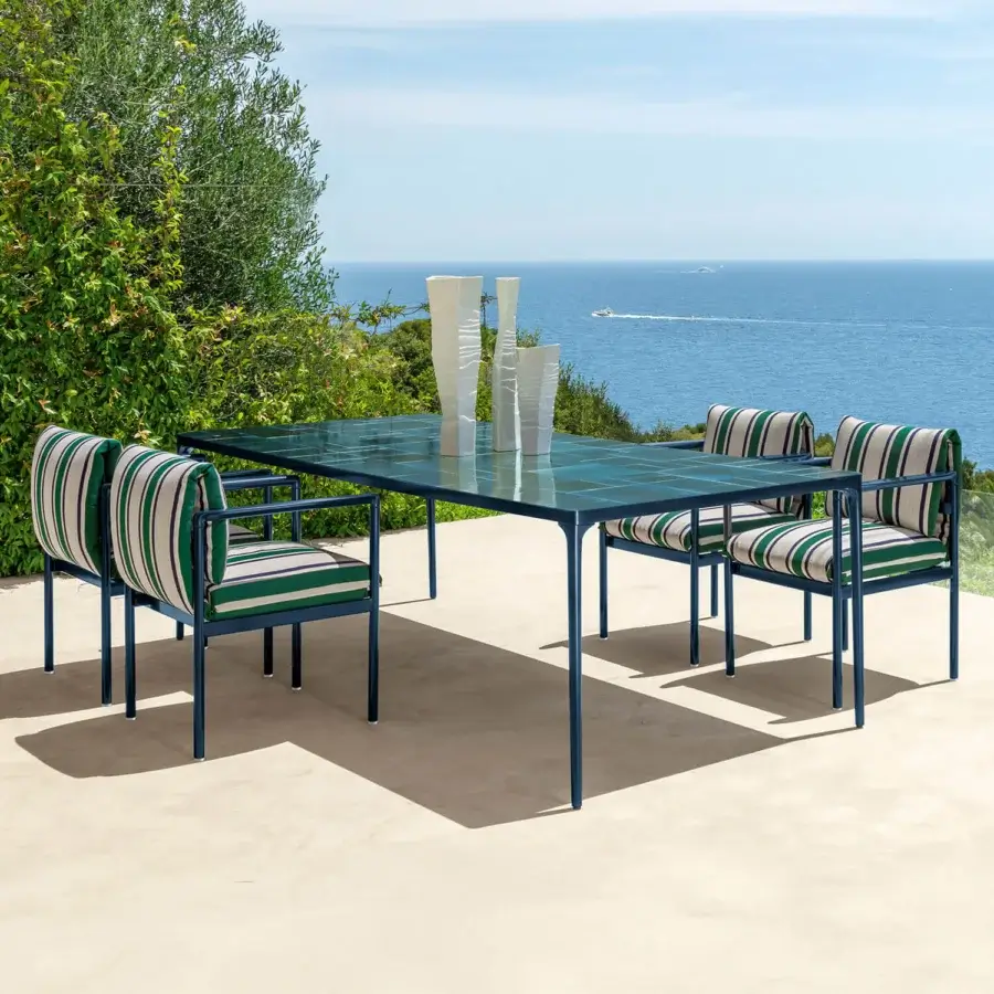Sophisticated Talenti Nalu table with teal glass tabletop and dark blue matte metal frame crafted in Italy