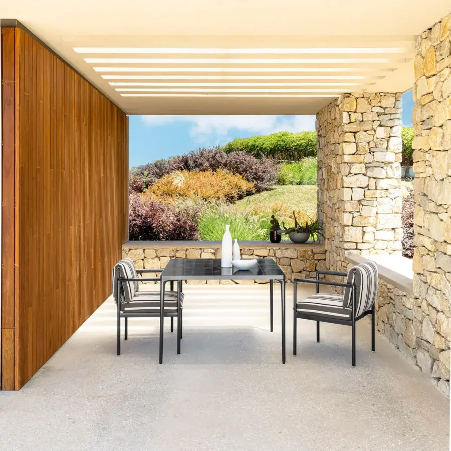 Distinguished Talenti Nalu table with dark-toned tabletop and matte black metal frame in a glossy finish