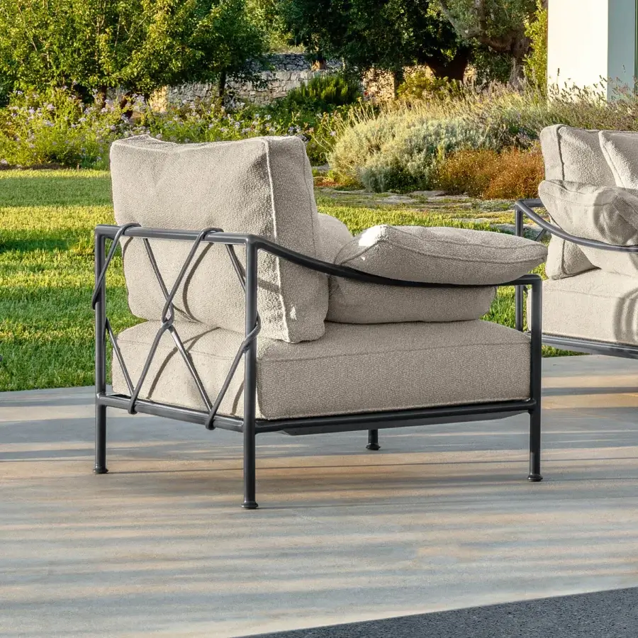 Elegant Talenti Capri lounge chair with neutral beige textile cushions and dark matte metal structure