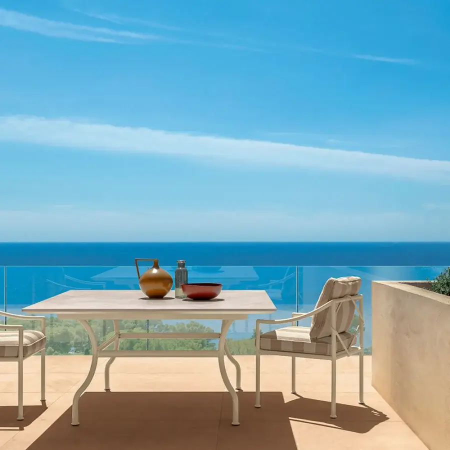 Distinguished Talenti Capri table with light neutral ceramic tabletop and robust white metal frame exhibiting a smooth matte finish
