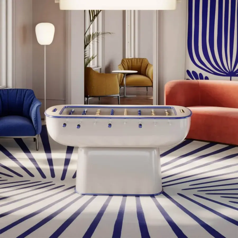 Distinguished Vismara Oskar foosball table with off-white lacquered structure and glossy finish, showcasing gold and blue aluminum players on tempered glass
