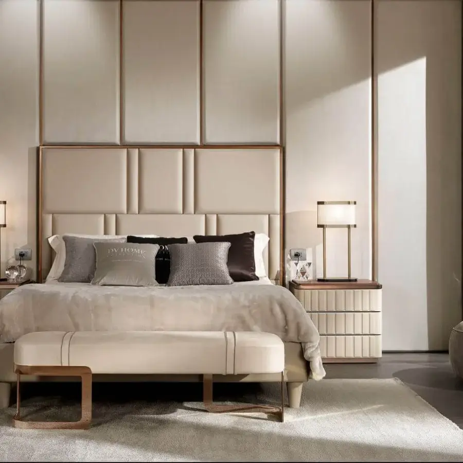 Distinguished DV Home Collection Elite bed with vertically stacked padded panels upholstered in light beige textile and bronze finish steel frame