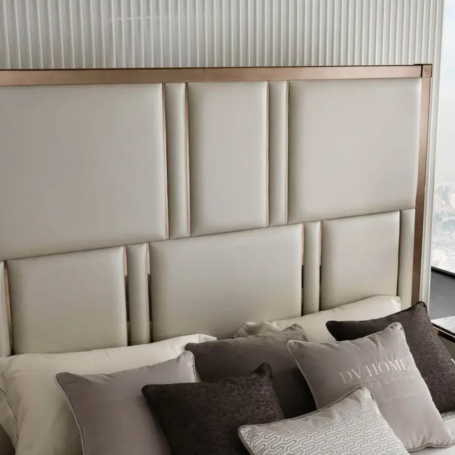 Superior DV Home Collection Elite bed with neutral textile panels and a refined steel border in rose-gold or bronze finish
