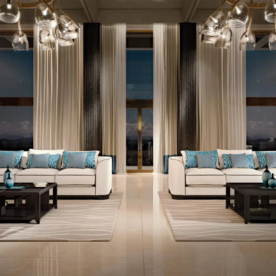 Distinguished BelMondo Palais Royal sofa upholstered in smooth off-white textile with dark trim and blue patterned accent pillows