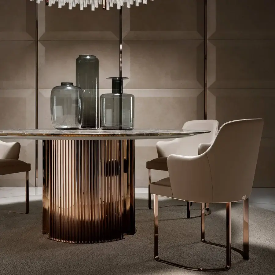 Exclusive DV Home Collection Deco armchair with light beige textile upholstery and glossy copper steel base