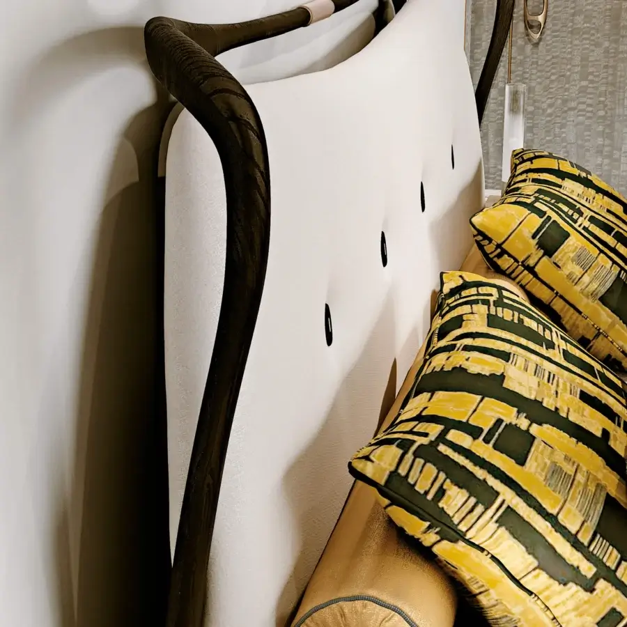 Distinguished BelMondo by Bellotti Ezio Crono bed with curved headboard upholstered in cream textile and dark wood frame with leather stitching