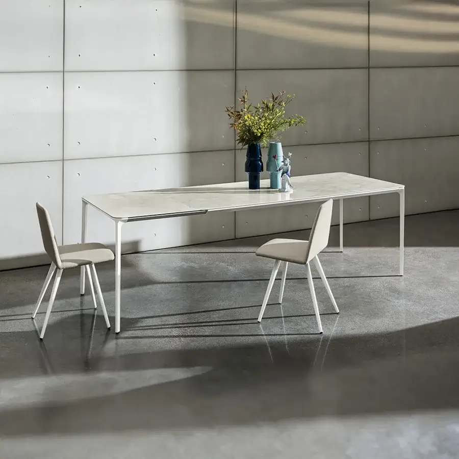 Elegant Sovet Italia Slim 20 table with a light-colored MDF top and lacquered aluminum frame exhibiting a sleek aesthetic