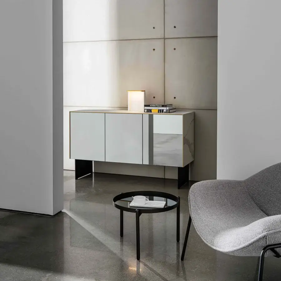 Distinguished Sovet Italia Kala sideboard with light gray structure and glossy marble-like doors accented by brass finish profiles and black metal base