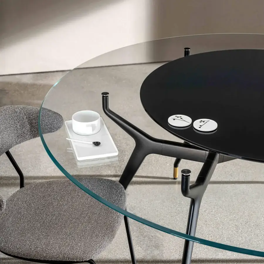 Distinguished Sovet Italia Arkos XXL table with transparent glass top revealing opaque black surface and lacquered black aluminum legs with gold accents