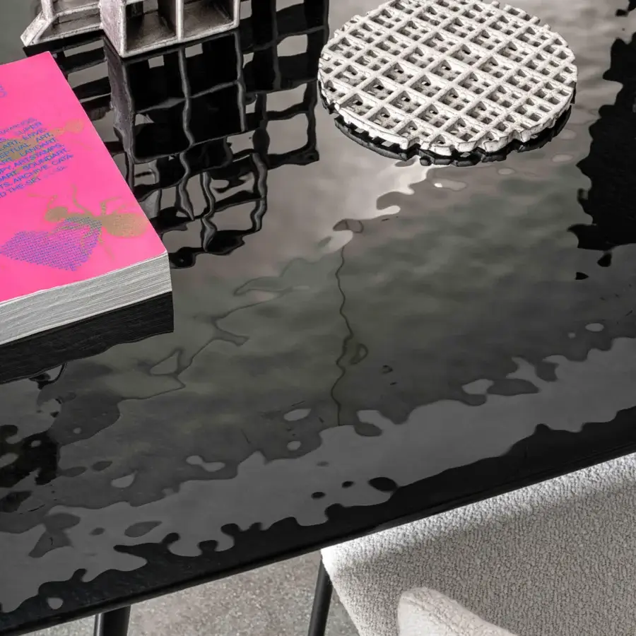 Distinguished Sovet Italia Arkos table with glossy black tempered glass and dark lacquered aluminum legs exhibiting a rippled surface