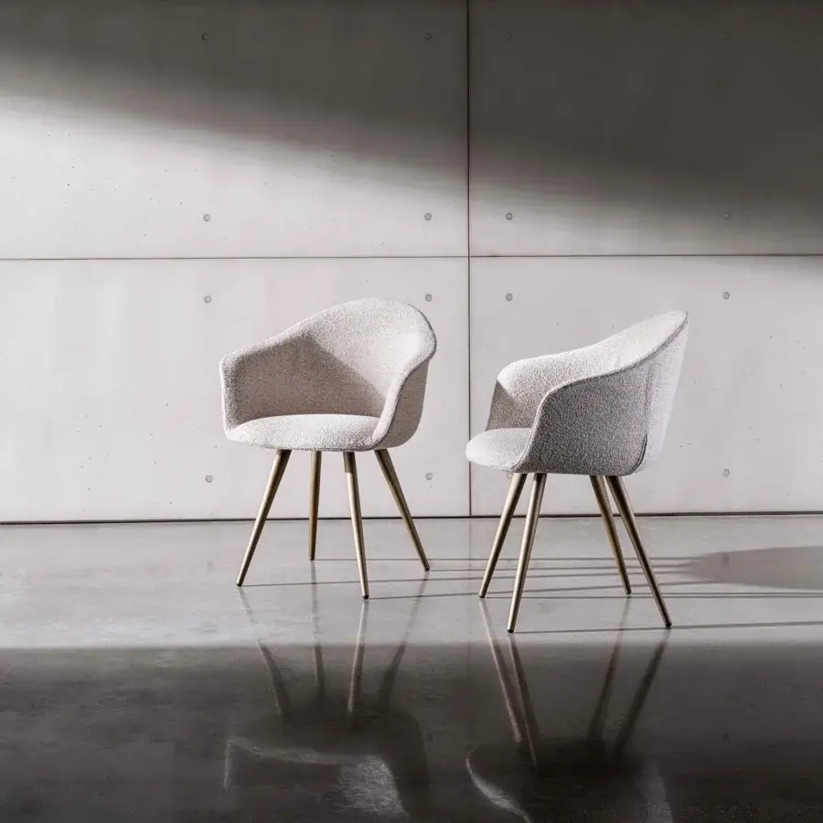 Distinguished Sovet Italia Dama chair with flexible polyurethane body upholstered in light textured textile and warm matte metal legs