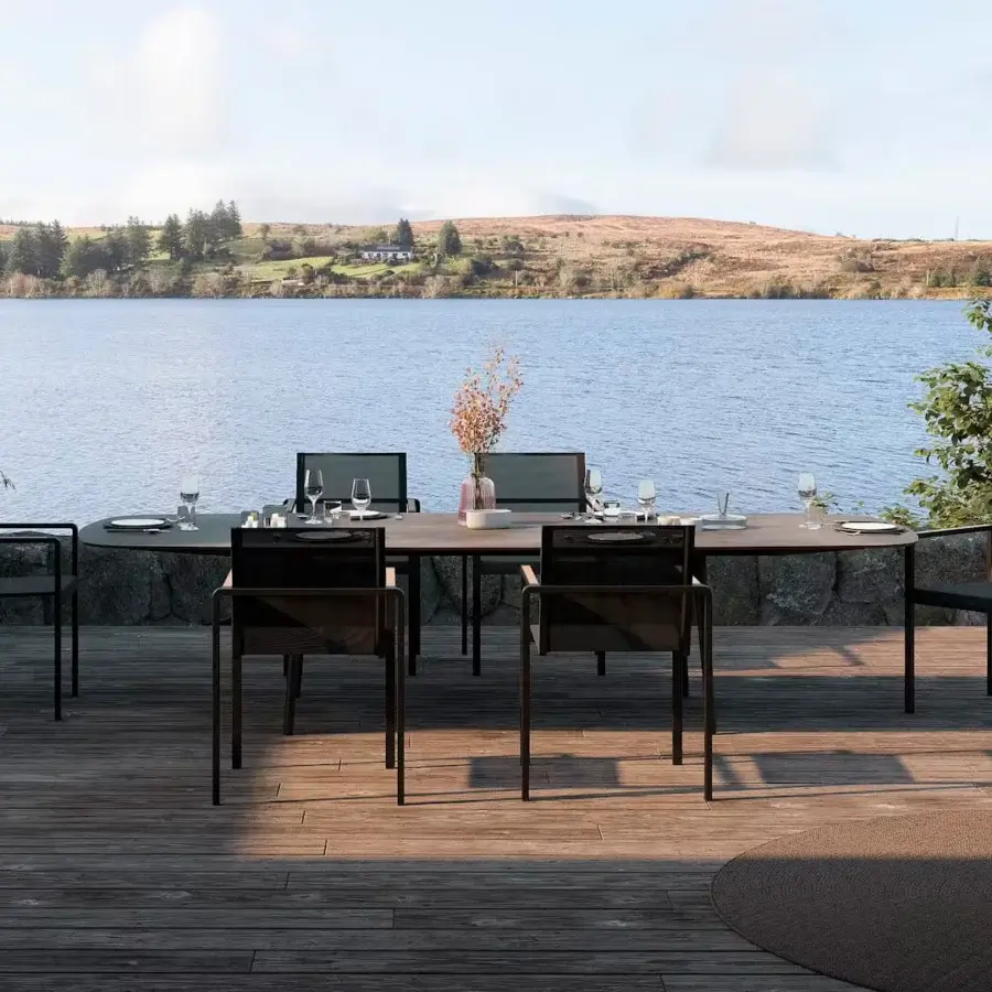 Elegant Royal Botania Styletto table with tapered legs in coated aluminum and a round ceramic top with uniform finish