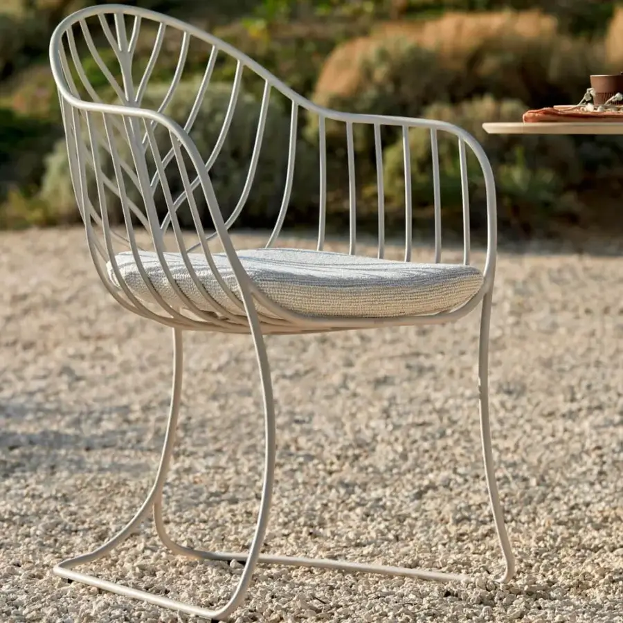 Distinctive Royal Botania Folia armchair with curved metal structure and matte finish captures attention through minimalist design