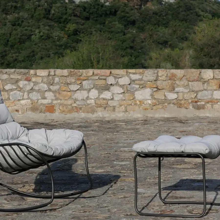 Elegant Royal Botania Folia Rocking Lounge Chair with light gray tufted textile cushions and dark powder-coated metal frame including ottoman