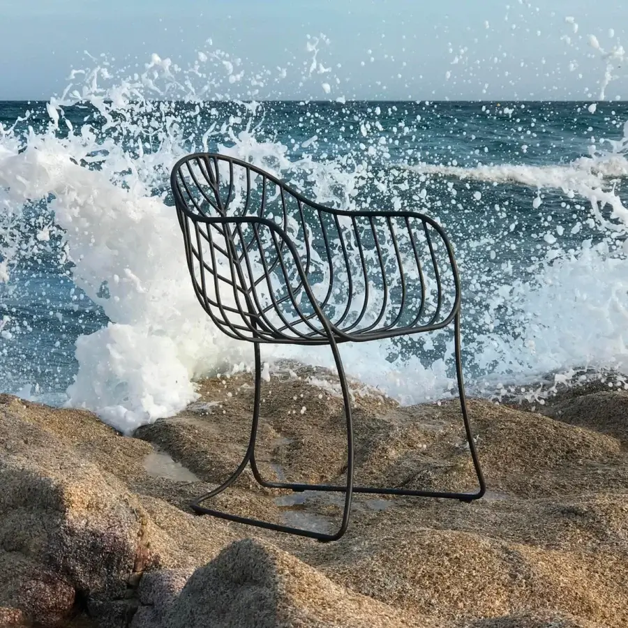 Elegant Royal Botania Folia armchair with a dark-toned metal frame and curvilinear silhouette crafted with a smooth matte finish