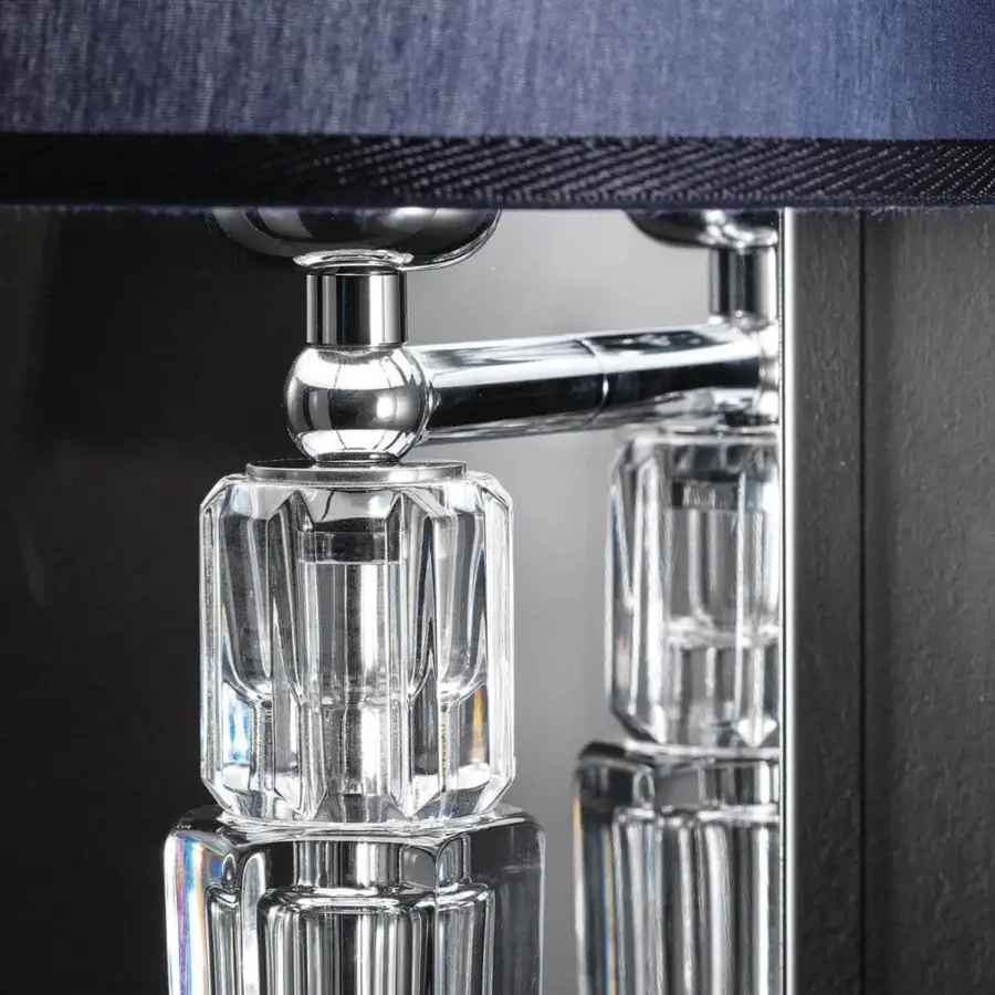 Lavish Italamp Spillo wall lamp with hand-carved transparent crystal elements and a glossy chrome-like metal structure topped with dark blue fabric