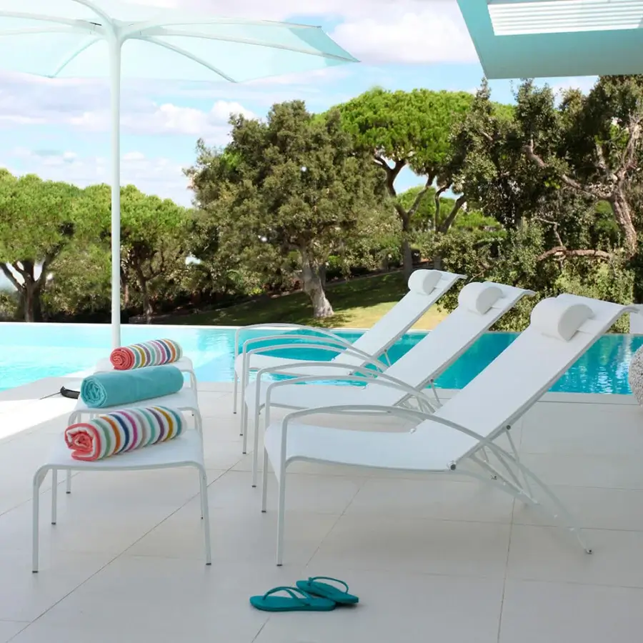 Elegant Royal Botania QT Lounger chair with crisp white Batyline and coated stainless steel in smooth matte finish