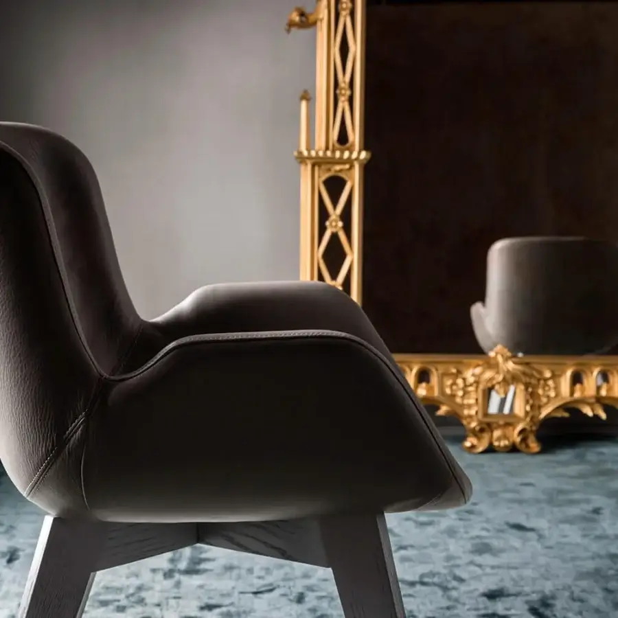 Distinguished OAK Nota armchair with curved form, muted gray leather upholstery and painted ash wood base