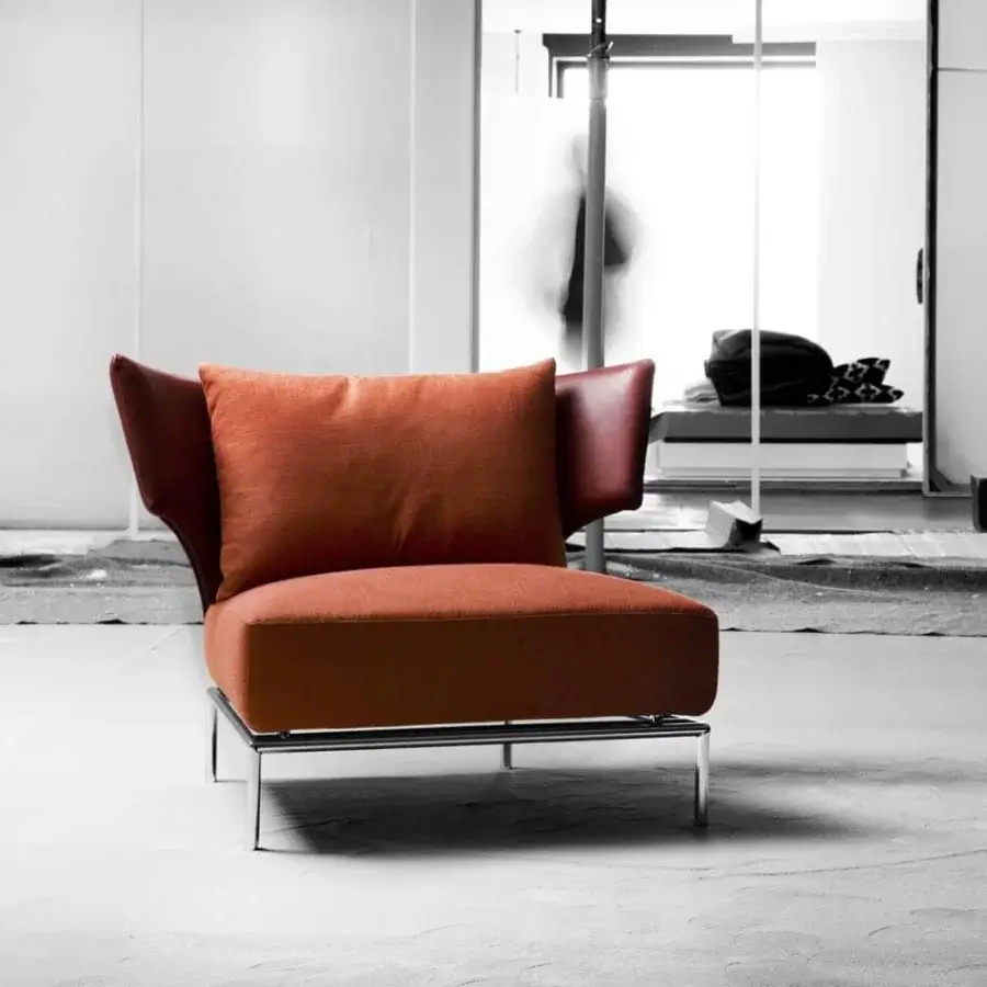 Distinctive Erba Abbraccio lounge chair with vibrant orange cotton upholstery and reddish-brown wings, built with a bright chrome steel frame