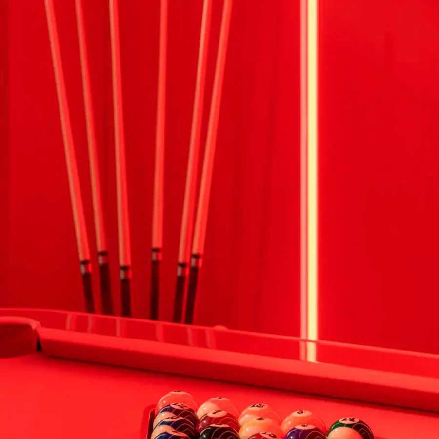 Exceptional Vismara Dandy pool table crafted with red glossy finish and luxurious leather covering a Simonis wool cloth surface