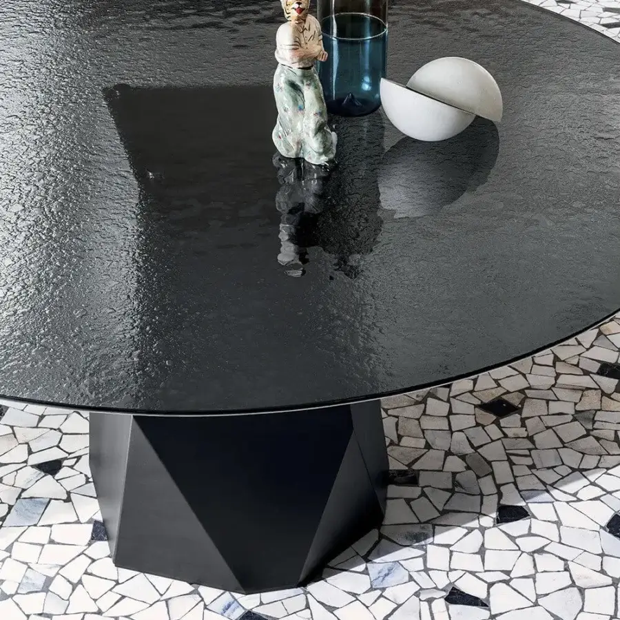 Distinguished Sovet Italia Deod round table with liquid glass top and dramatically angled lacquered metal base in deep charcoal