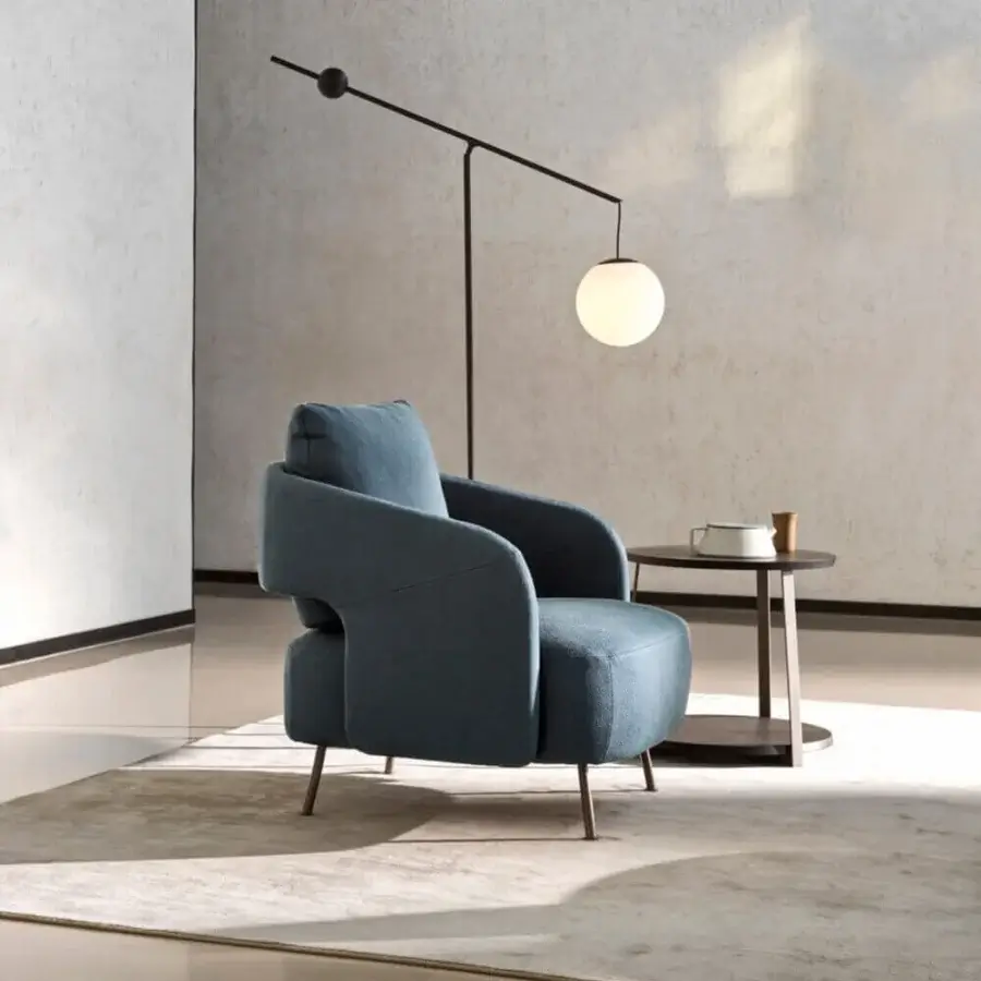 Superior Ditre Italia 356 lounge chair with enveloping silhouette upholstered in textured teal blue fabric and varnished metal legs