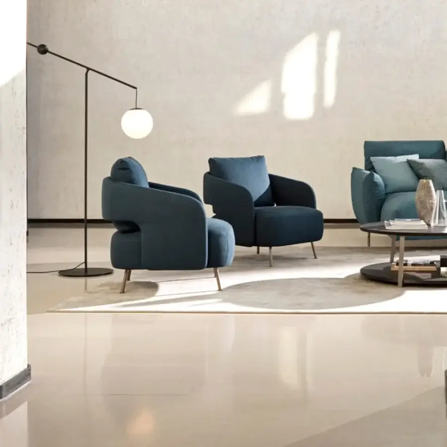 Distinguished Ditre Italia 356 lounge chair with enveloping form upholstered in smooth teal blue fabric or leather with light-colored wood legs