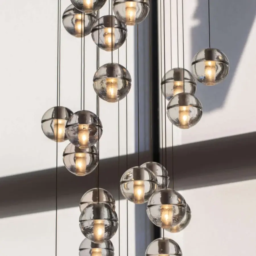 Elegant Bocci 14 Random Suspension lamp with articulated cast glass spheres in neutral gray and frosted cylindrical voids