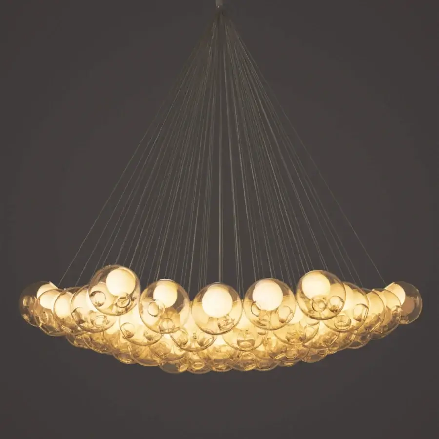 Exceptional Bocci 28 Cluster suspension lamp with numerous clear glass spheres illuminated by warm golden-yellow light and adjustable metal ring