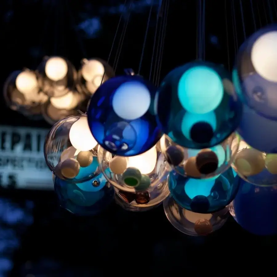 Exceptional Bocci 28 Cluster suspension lamp with hand-blown glass spheres in blue, teal, silver, and clear with milky white interiors crafted with dark cords