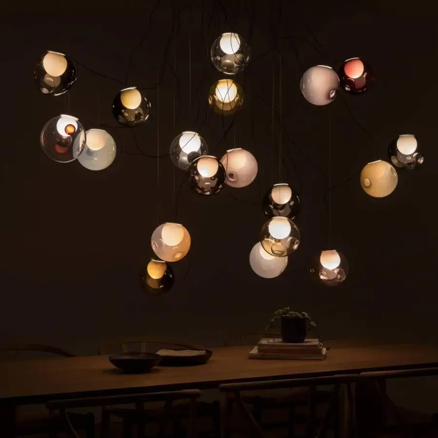Superior Bocci 28 sculptural lamp with individually suspended clear, amber, brown, and reddish-purple glass connected by dark matte cables