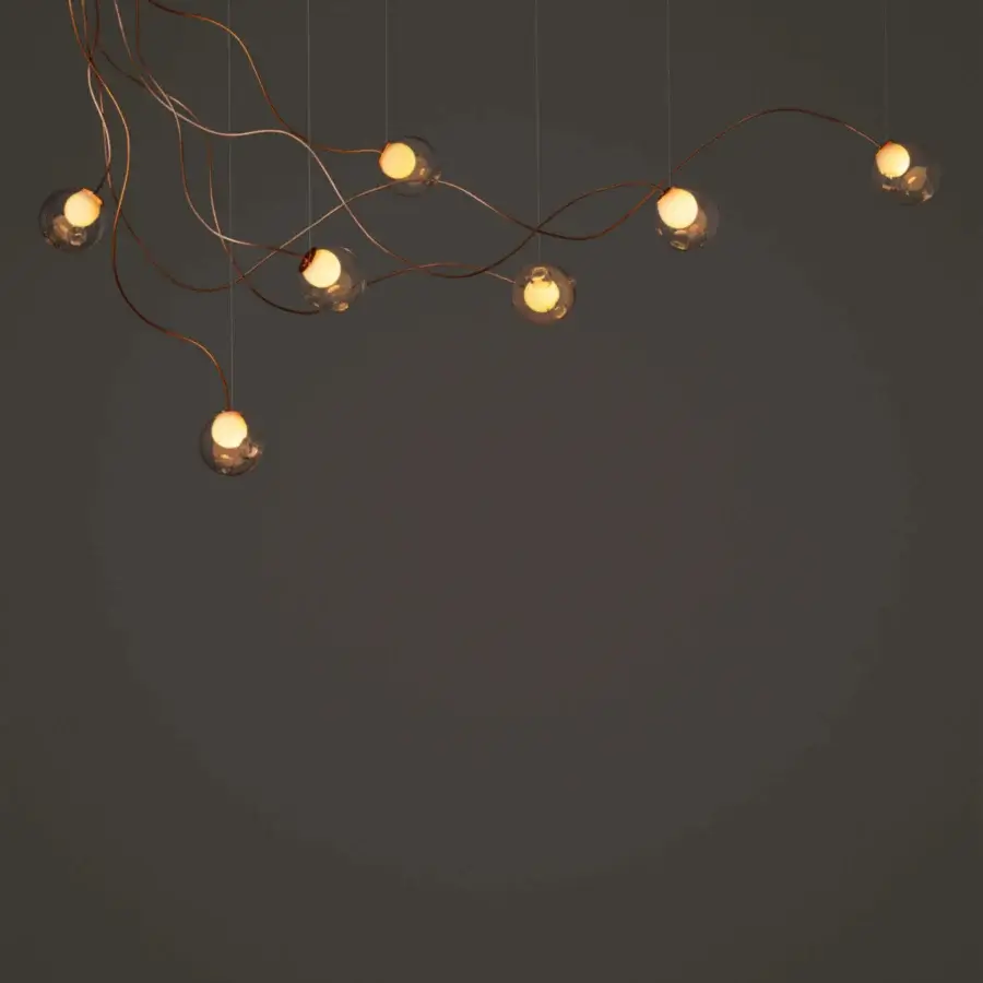 Distinguished Bocci 28 sculptural lamp crafted with clear glass and warm satin copper-toned metal for inviting illumination