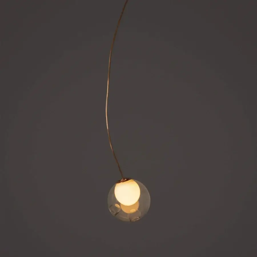Distinguished Bocci 28 single suspension lamp with gracefully curved form in clear glass and natural copper exhibiting evolving patina