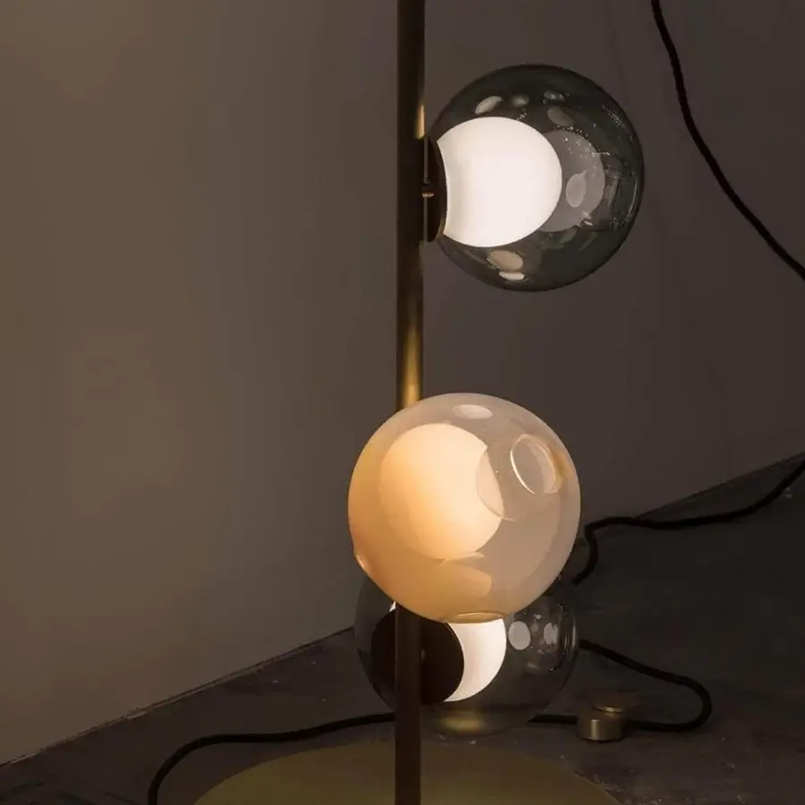 Elegant Bocci 28 Stem Floor Lamp with a slender metal stem and four smoky gray glass shades crafted with a brass finish
