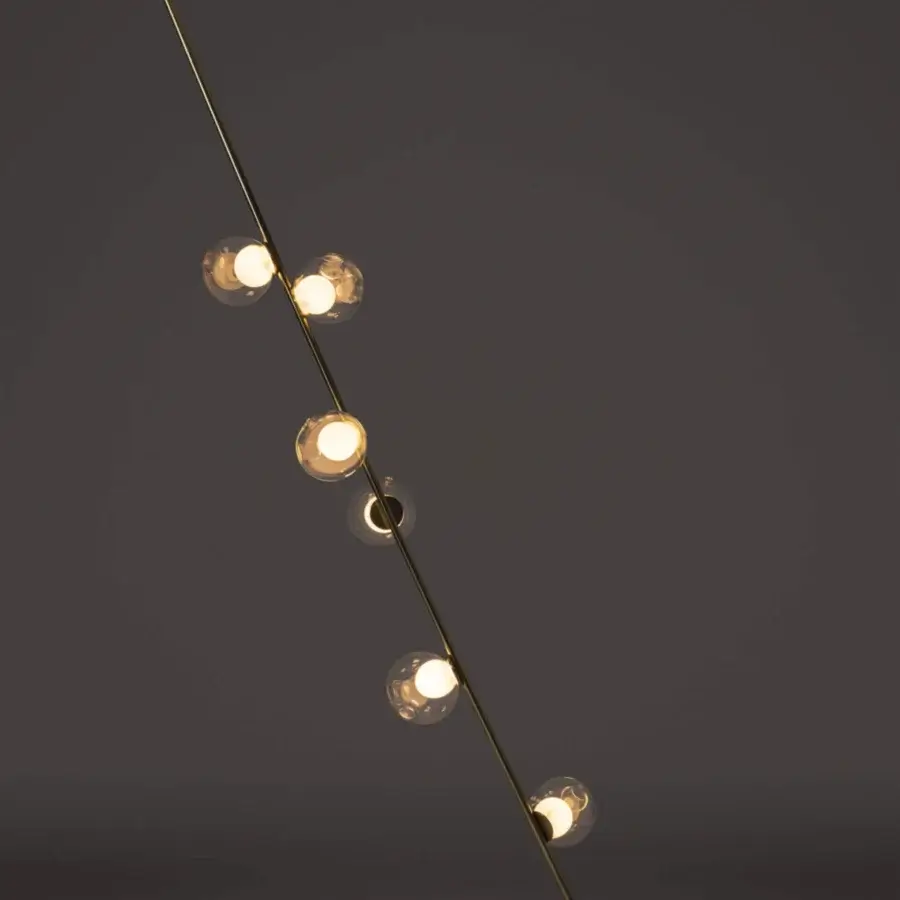 Sophisticated Bocci 28 Stem Floor to Ceiling Lamp crafted in clear glass with milk white cavities and a refined brass finish