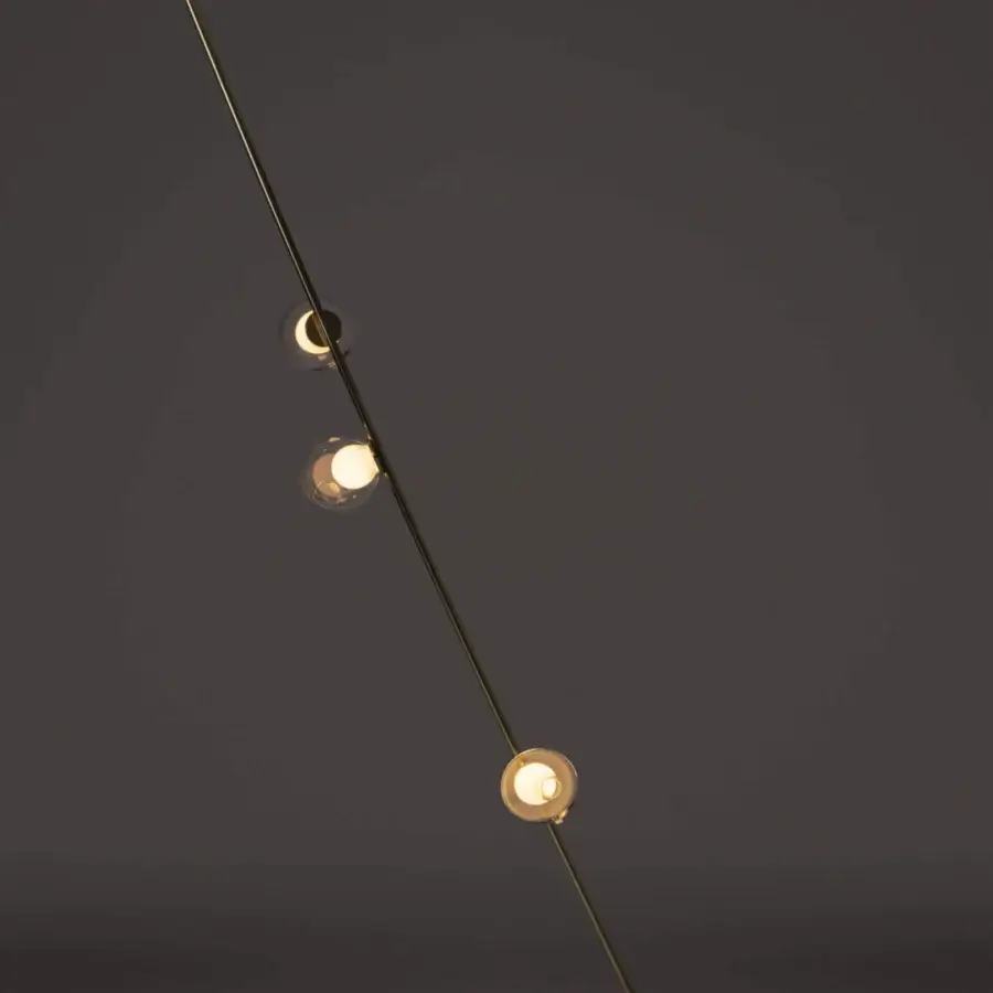Distinguished Bocci 28 Stem Floor to Ceiling Lamp crafted in brass with distorted clear glass spheres and milk white interiors