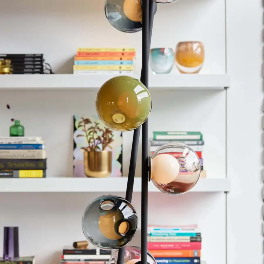 Exclusive Bocci 28 Stem Floor to Ceiling Lamp with a refined black metal structure and dynamic arrangement of clear, green, red, and smoky grey-blue glass spheres