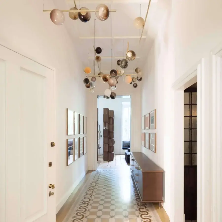 Sophisticated Bocci 28 Stem suspension lamp with unlacquered brass stems supporting clear glass exterior spheres and milk white interiors