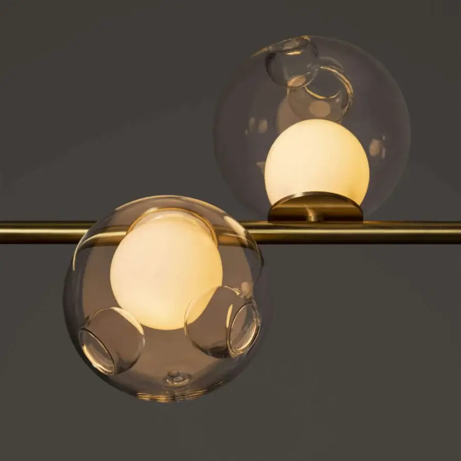 Exceptional Bocci 28 Stem suspension lamp with clear glass spheres and unlacquered brass supporting a milk white interior holder
